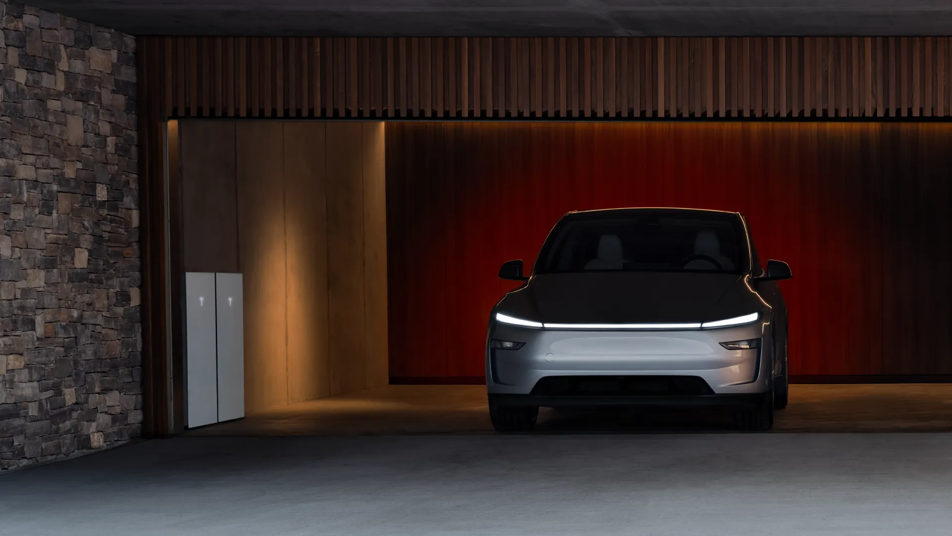 Electric vehicle charging in modern garage with Tesla Powerwall batteries